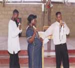 Rev. Bah prays for an over-stilled pregnant woman